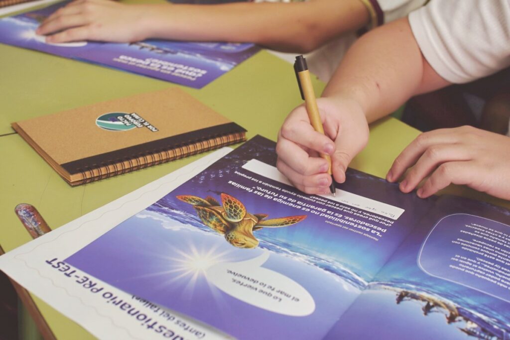 Alumnado trabajando con el cuaderno del taller ELO – Elegimos los Océanos sobre pesca sostenible